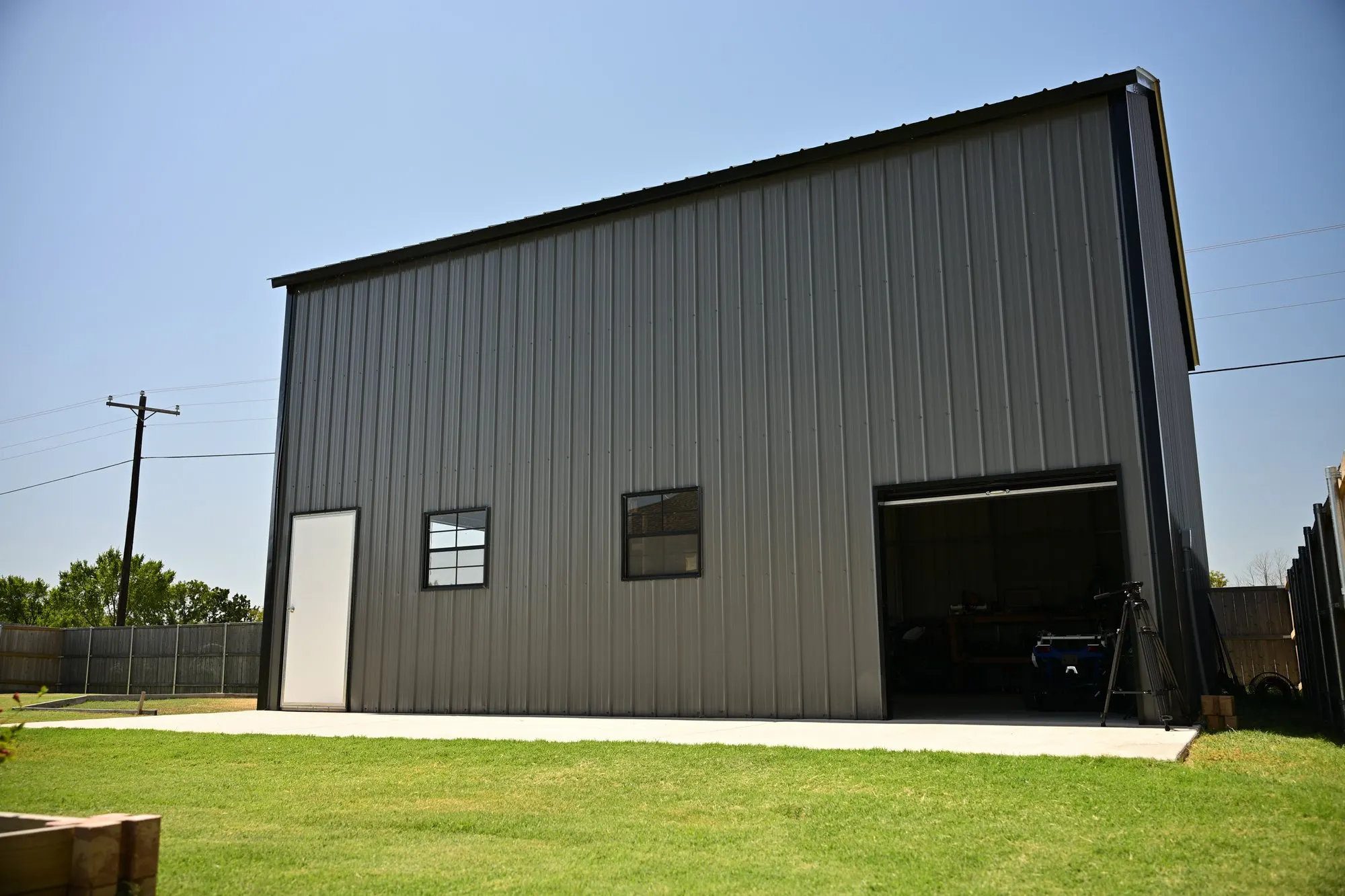 Side view of the tall gray metal building in late afternoon light
