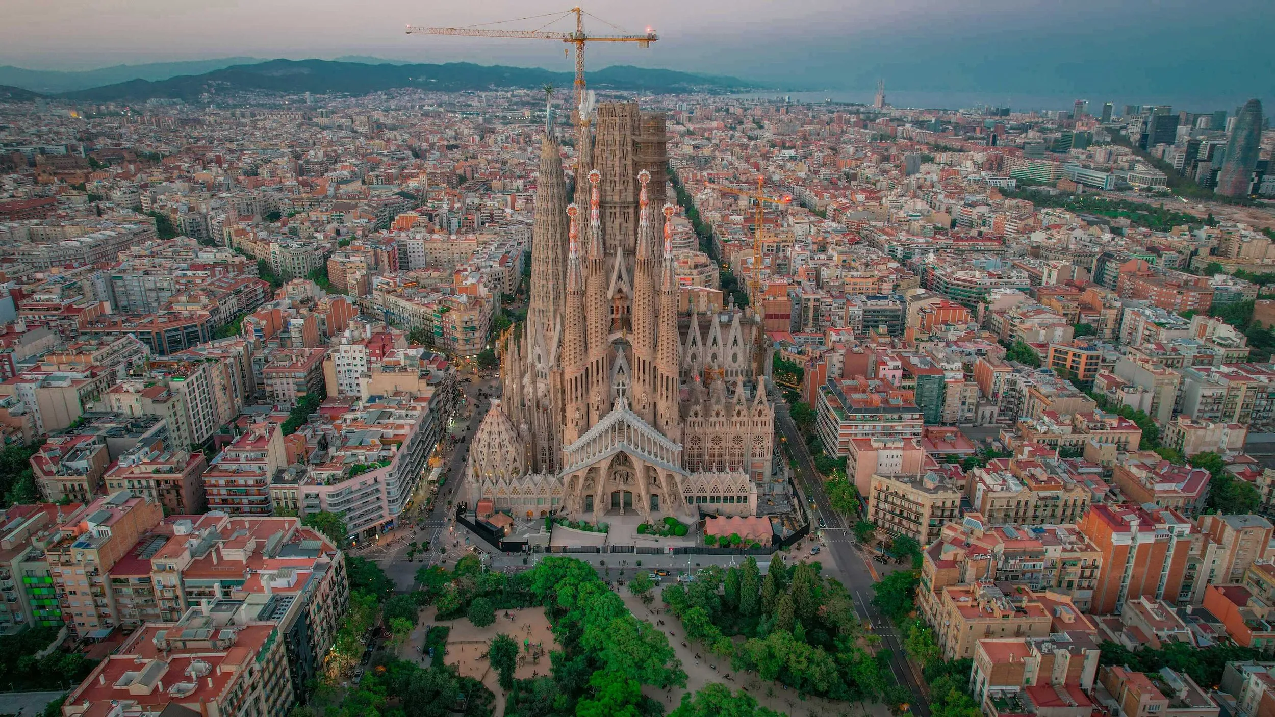 Aerial drone view of a dense city grid at dusk