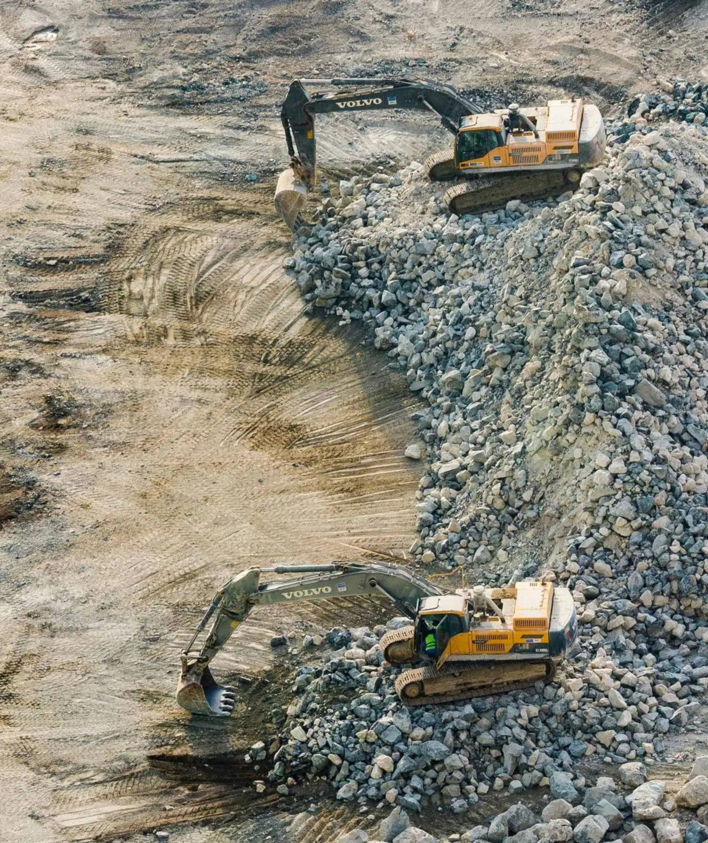 Overhead drone photograph of two excavators working an active construction site