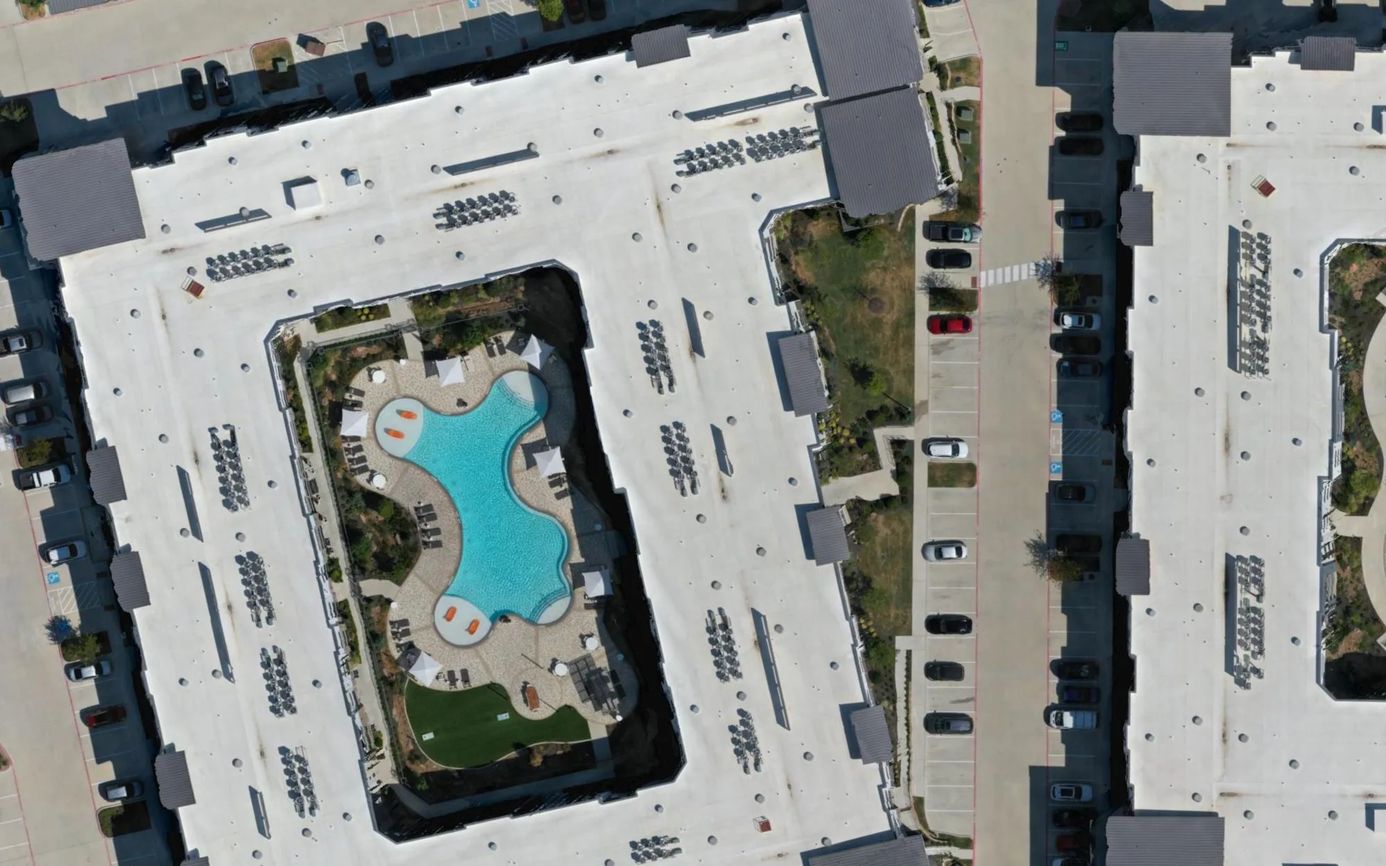 Full-resolution crop of the orthomosaic showing a courtyard, parking stripes, and individual cars
