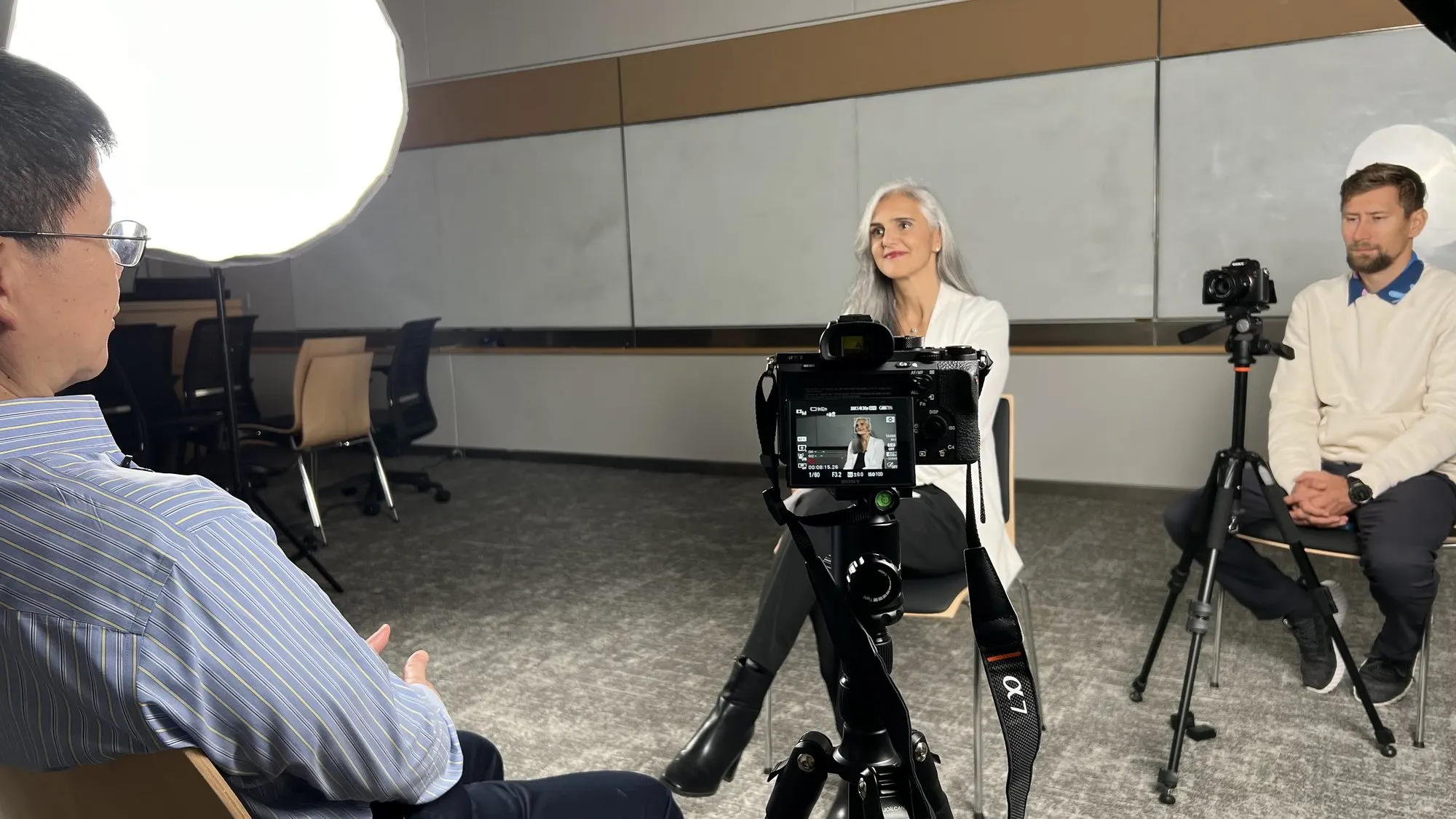 Interview host framed on the camera monitor during a Conversations with Giants in Medicine shoot