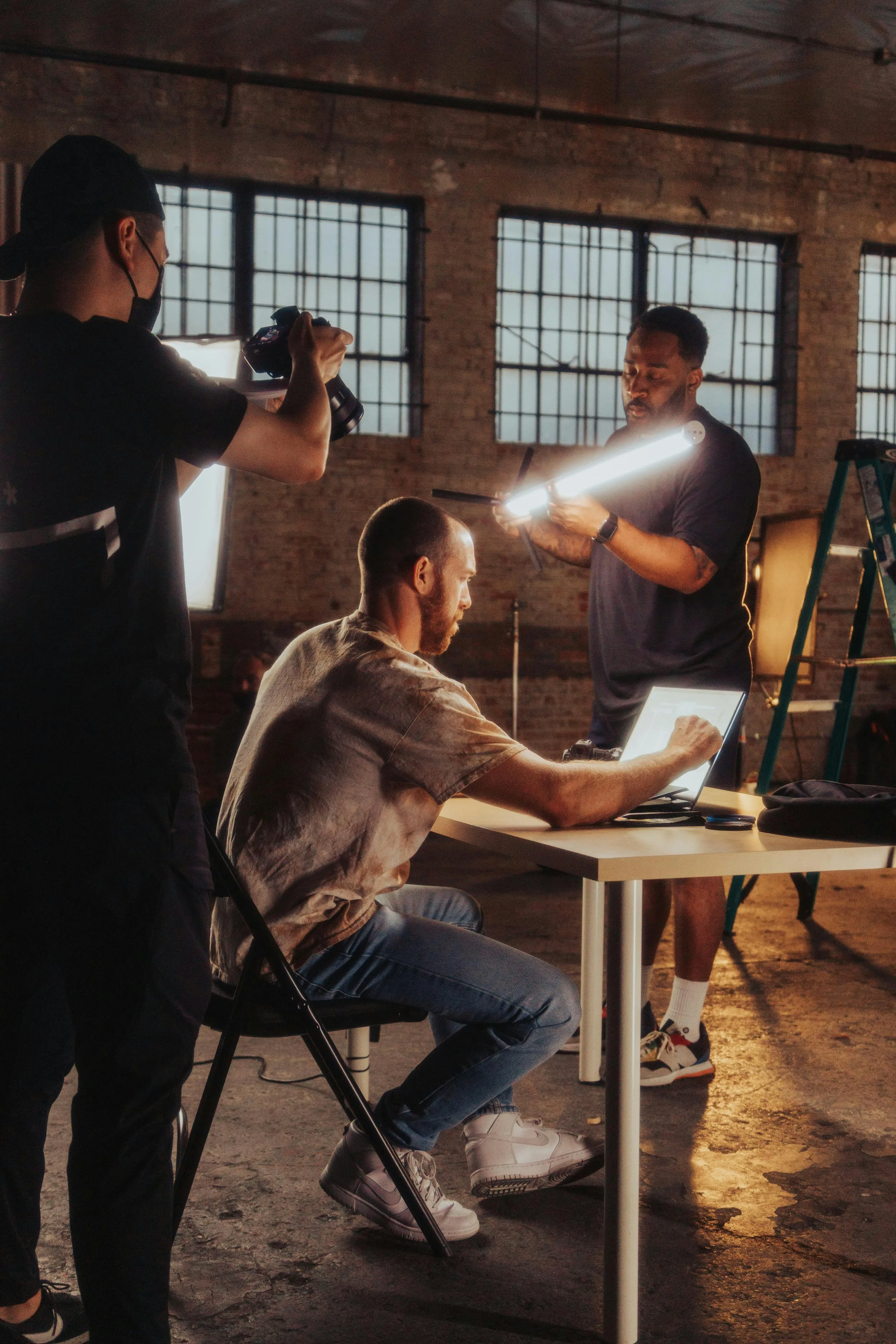 Image Media Lab crew lighting and filming a seated subject on a Dallas warehouse set