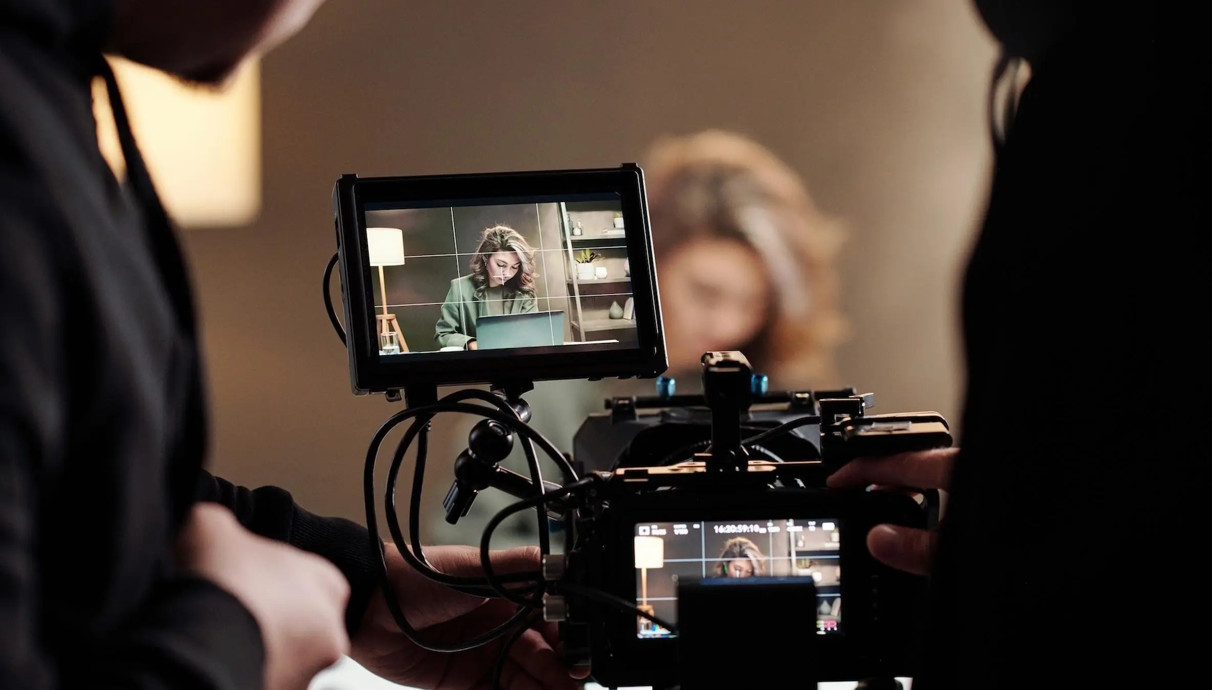 Director watching an interview subject on a production monitor during a testimonial shoot