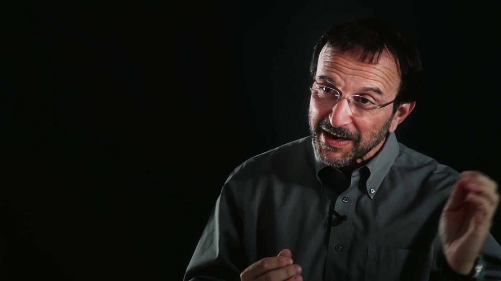 Virologist Vincent Racaniello explaining viruses on a dark interview set